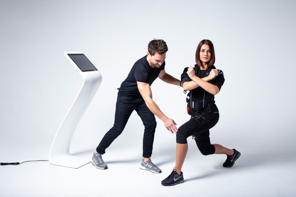 Private personal trainer Boca Raton adjusting an EMS fitness suit
